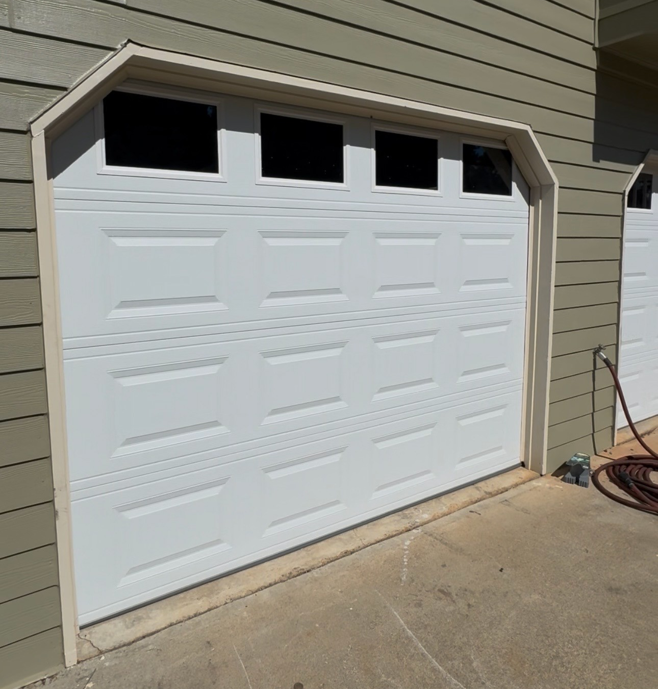 Professional technician repairing modern garage door system